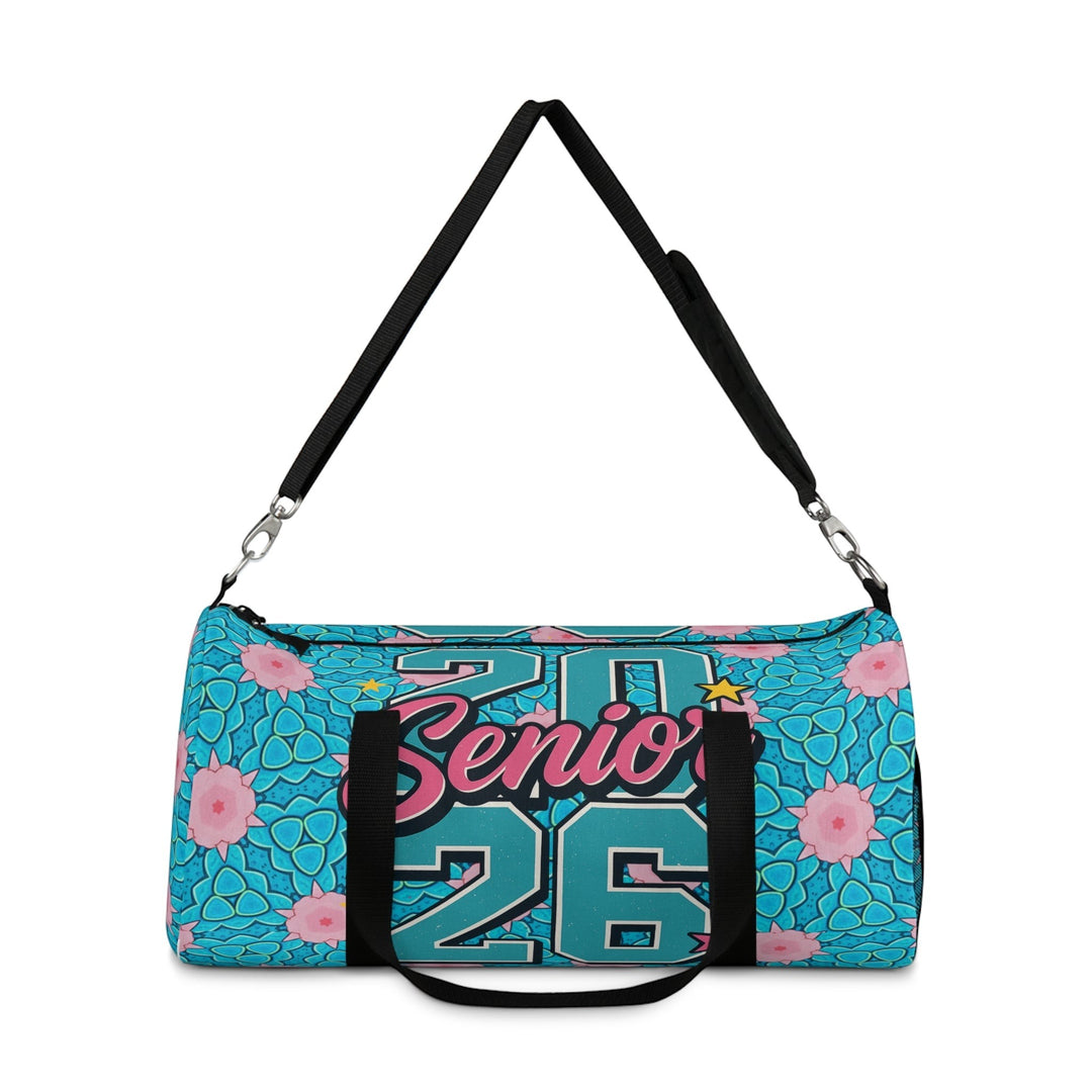 Sea Dragon Dreams 2026 Graduate duffel bag in blue with pink floral pattern, adjustable strap, and black handles.
