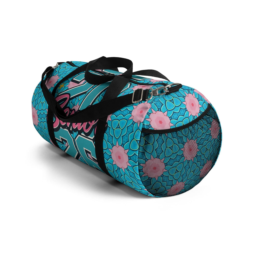 Sea Dragon Dreams 2026 Graduate duffel bag in blue with pink floral patterns, featuring a mesh side pocket and strap.