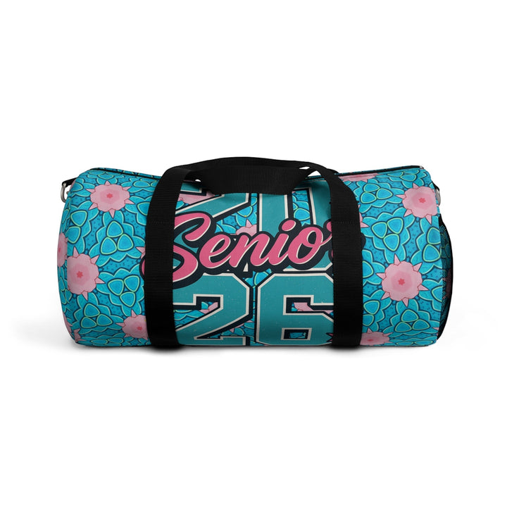 Sea Dragon Dreams 2026 Graduate duffel bag in teal with pink floral patterns, black handles, and bold typography.