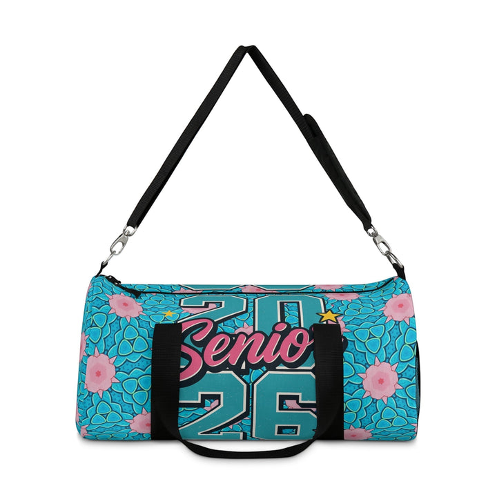 Sea Dragon Dreams 2026 Graduate duffel bag in blue with pink floral pattern, black handles, and adjustable strap.