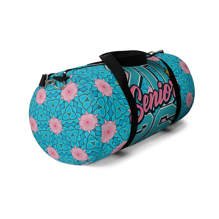 Sea Dragon Dreams 2026 Graduate duffel bag in blue with pink floral pattern, black straps, and side view.