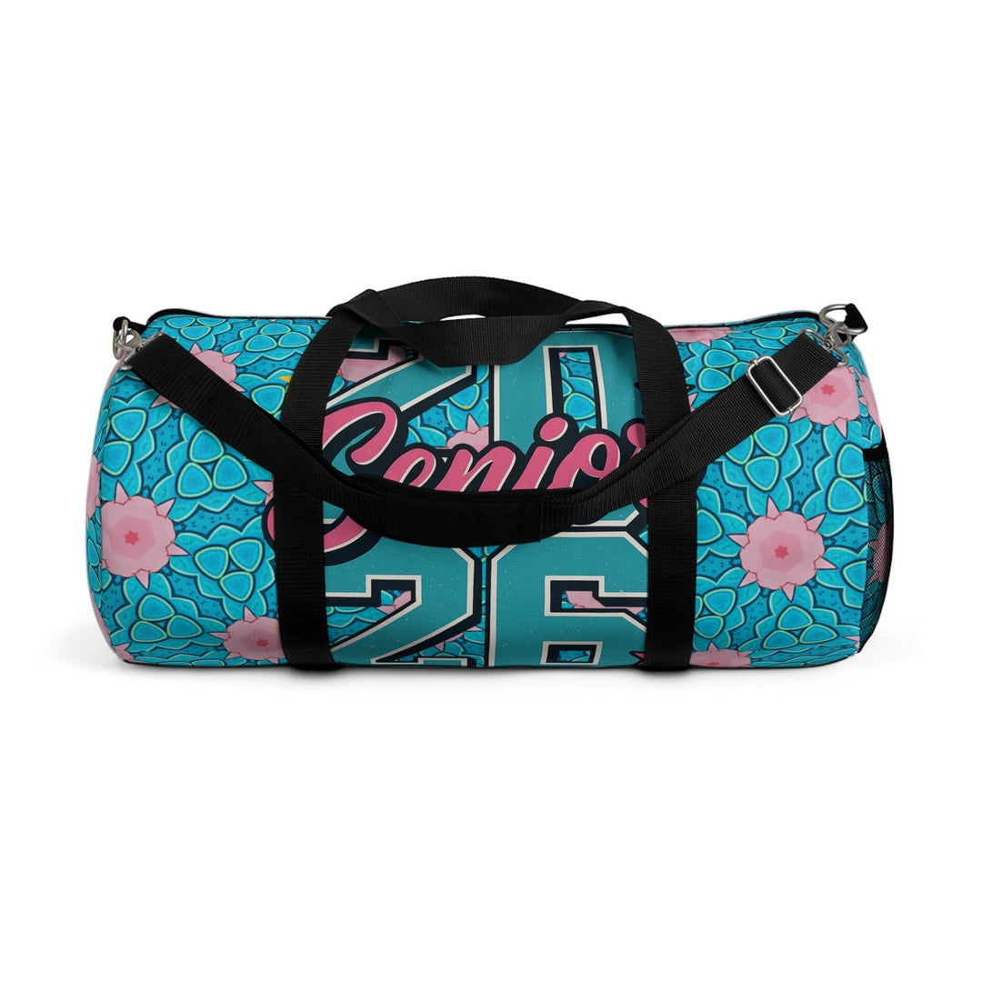 Sea Dragon Dreams 2026 Graduate duffel bag in blue and pink with floral pattern, adjustable strap, and black handles.