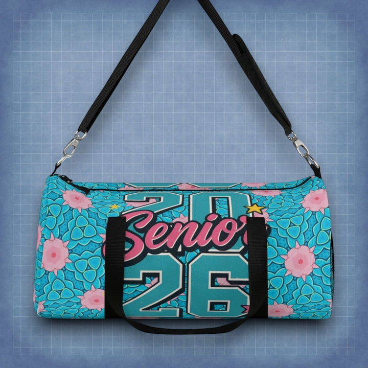 Sea Dragon Dreams 2026 Graduate duffel bag in teal with pink floral pattern, adjustable strap, and black accents.