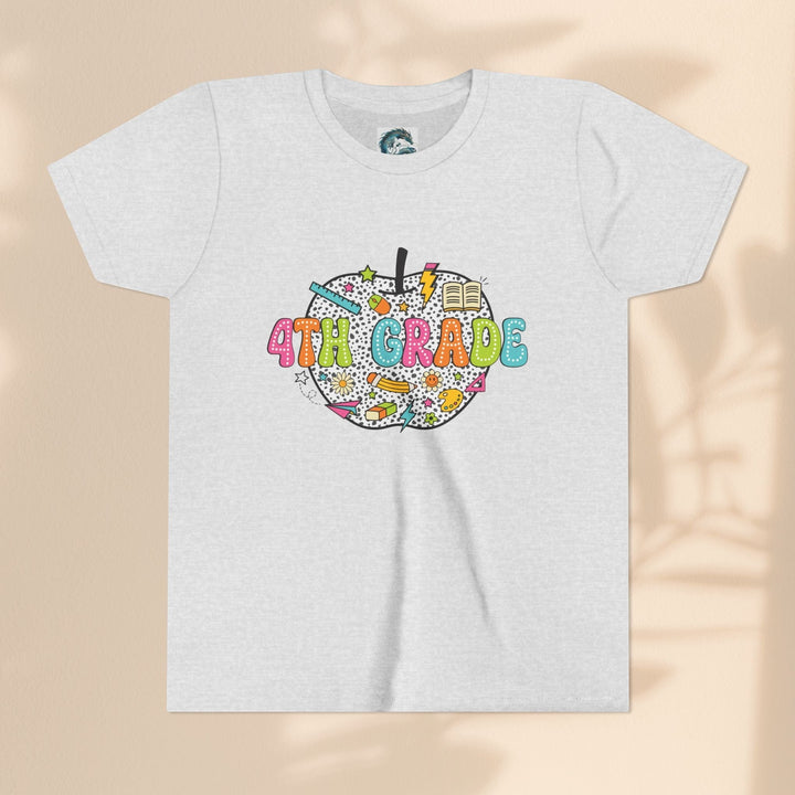 Sea Dragon Dreams 4th grade youth t-shirt in light grey with a colorful apple graphic featuring school supplies.