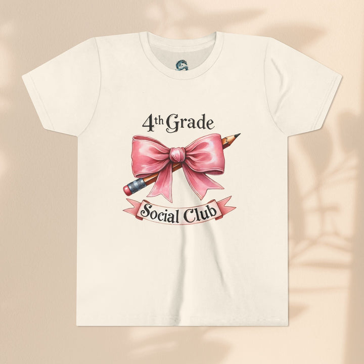 Sea Dragon Dreams youth short sleeve tee in cream cotton featuring a 4th Grade Social Club graphic with a pink bow.