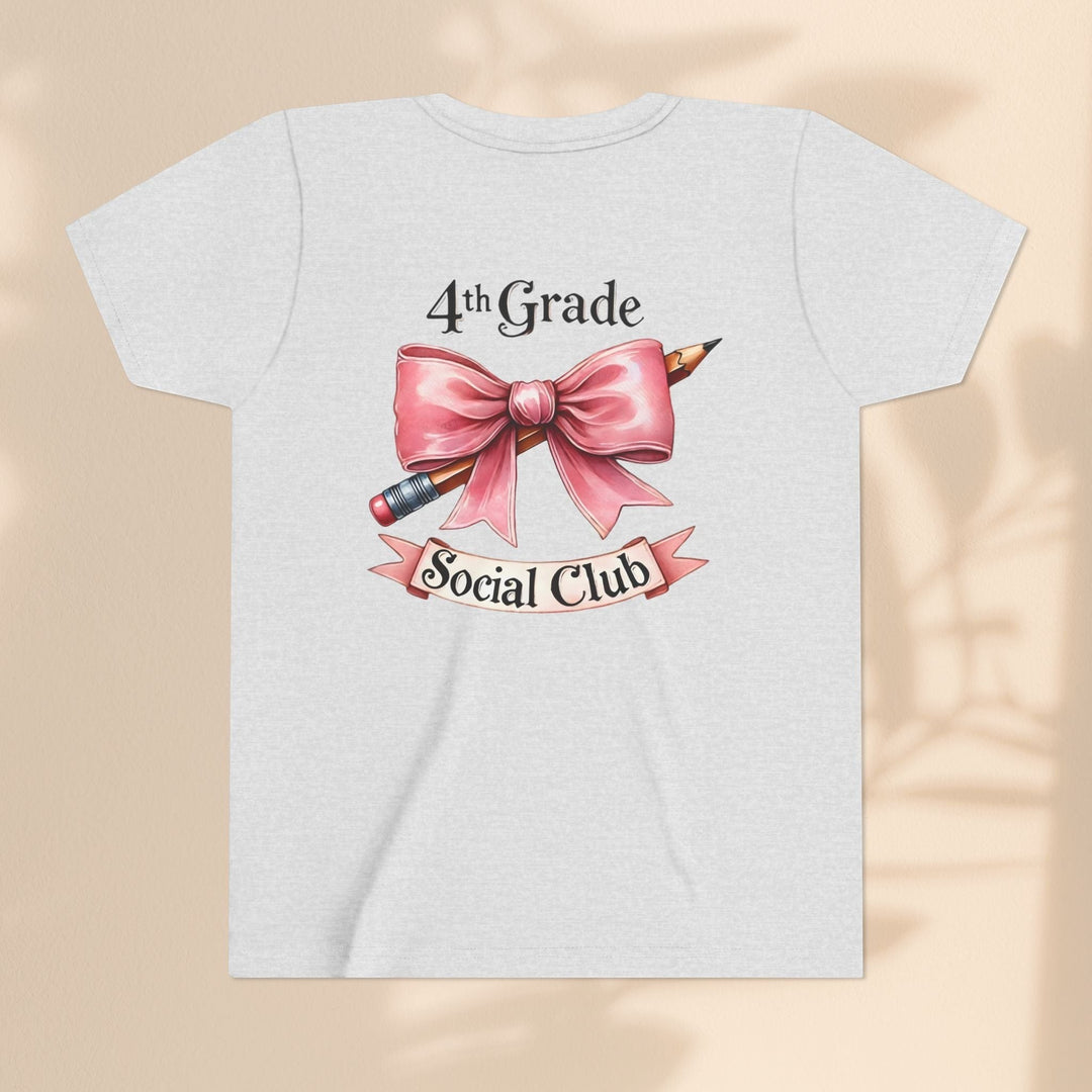Sea Dragon Dreams youth short sleeve tee in heather grey with a 4th Grade Social Club graphic featuring a pink bow and pencil.