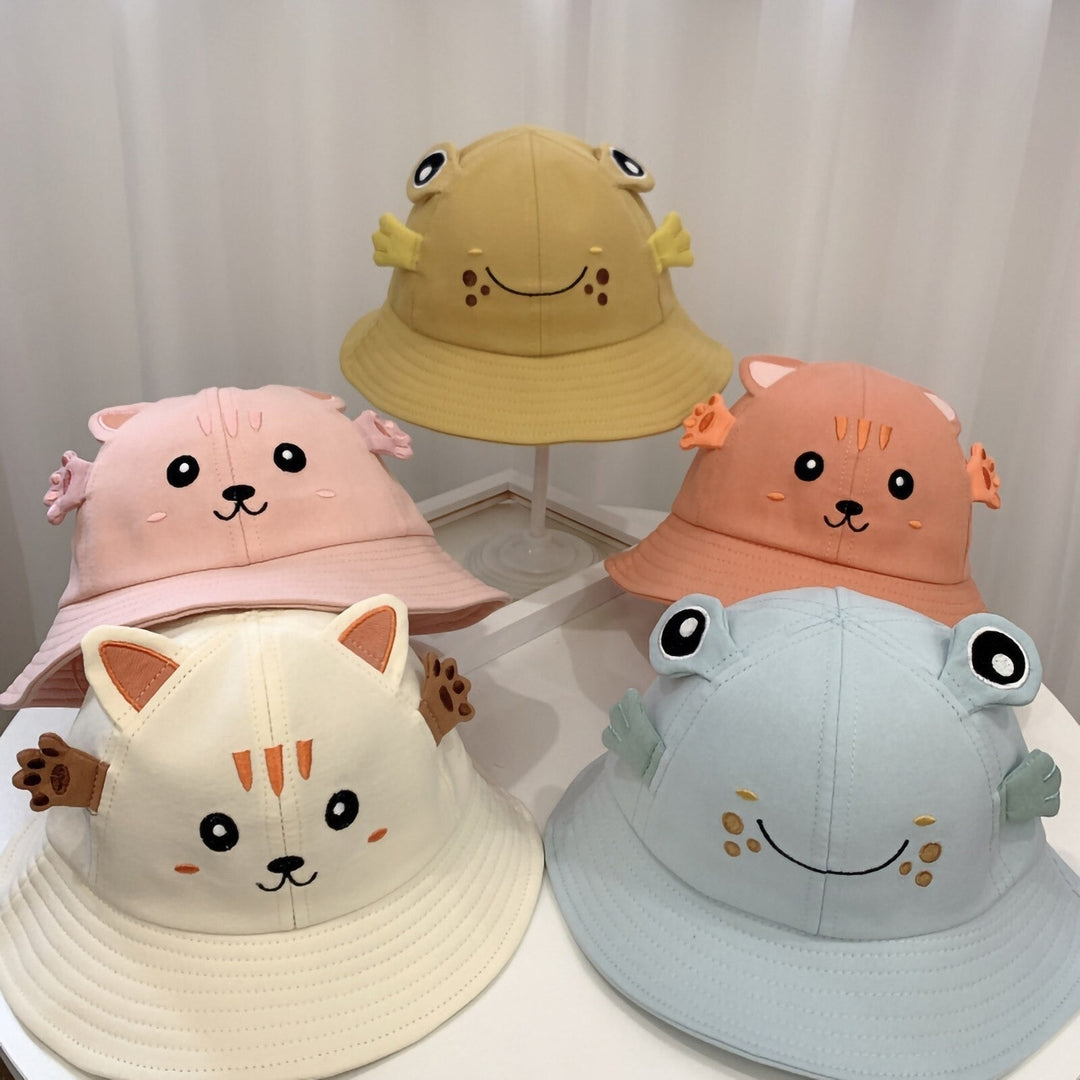 Sea Dragon Dreams baby bucket hats featuring cute kitten and frog designs in pastel pink, yellow, orange, and blue.