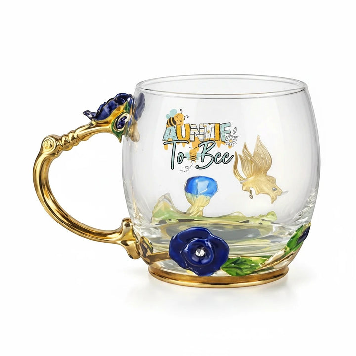 Sea Dragon Dreams Aunt To Be glass mug with gold handle, enamel floral details, and bee-themed decorative accents.