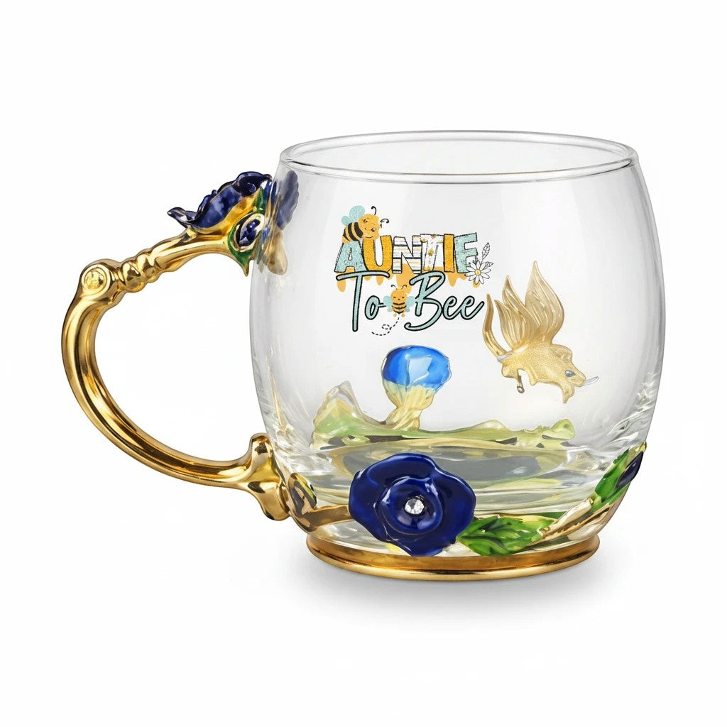 Sea Dragon Dreams Auntie To Bee glass mug with gold handle, blue enamel flowers, and bee-themed floral design.