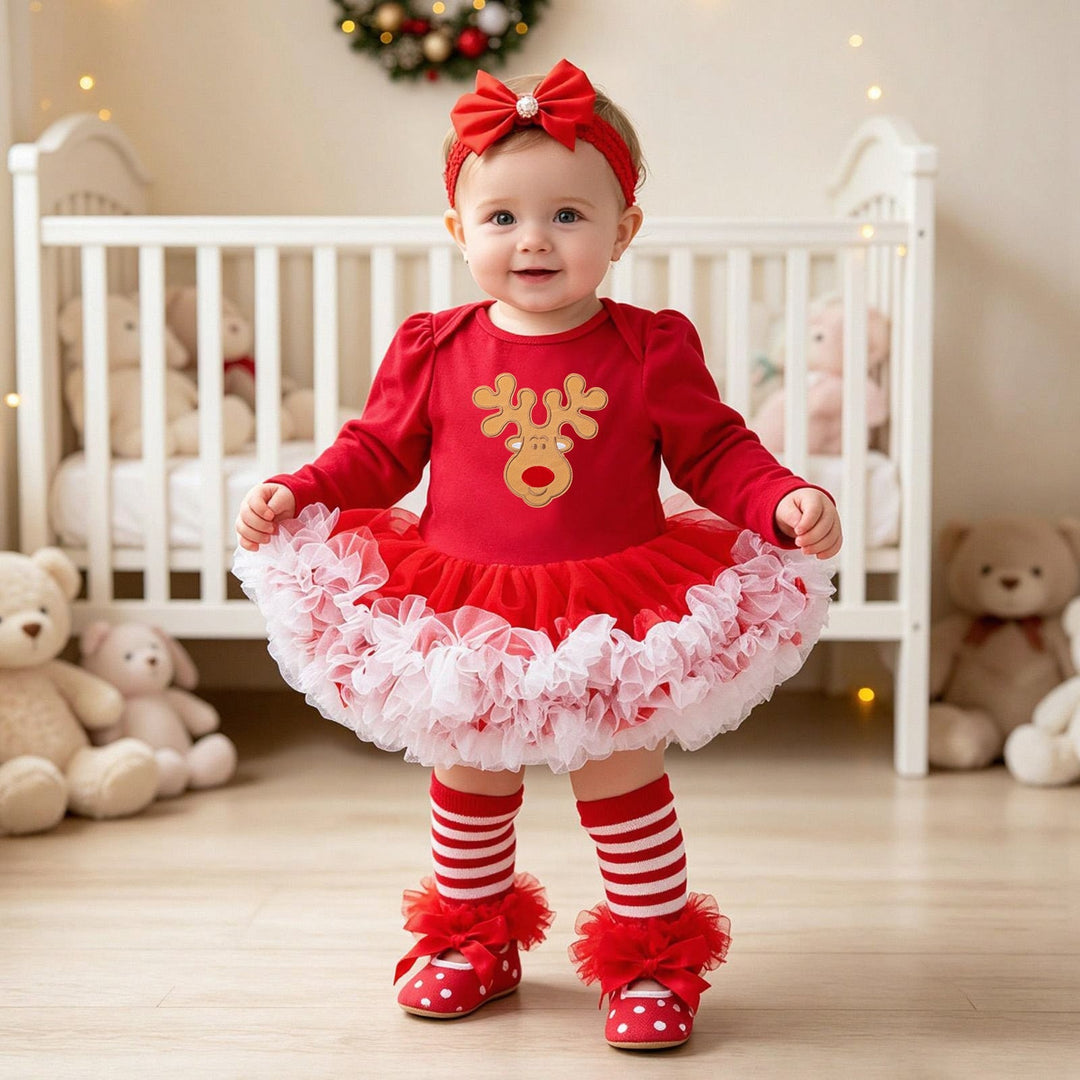 Sea Dragon Dreams baby girl wearing a red Christmas romper dress with a reindeer graphic, tulle skirt, and matching headband