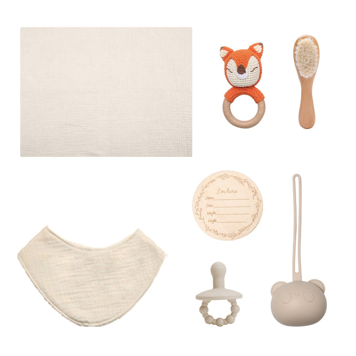 Sea Dragon Dreams baby gift set featuring a muslin cloth, fox rattle, wooden brush, pacifier, and milestone card.