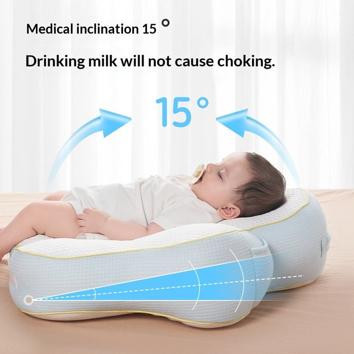 Sea Dragon Dreams nursing pillow with 15-degree incline, supporting a baby during feeding to prevent choking.