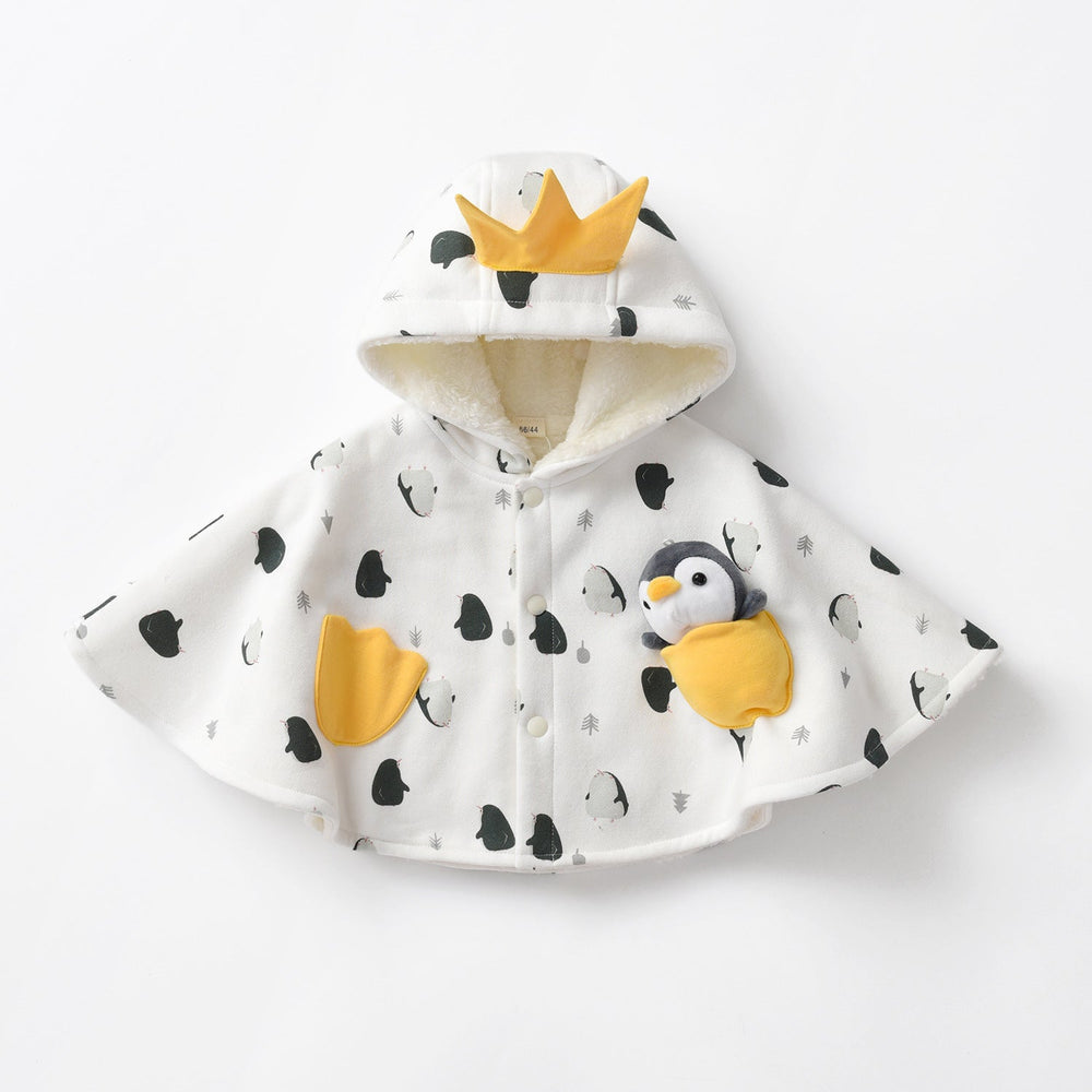 Sea Dragon Dreams white baby cloak with penguin print, yellow crown hood, and a plush penguin toy in the pocket.