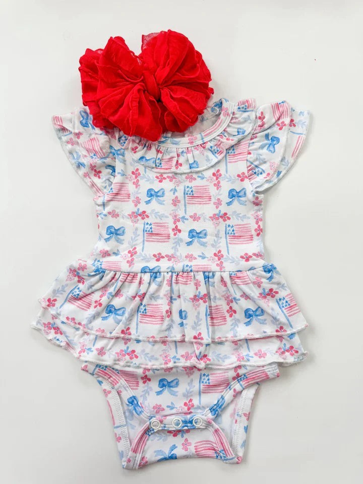 Sea Dragon Dreams bamboo onesie with American flag print, flutter sleeves, ruffled neckline, and layered tutu skirt.