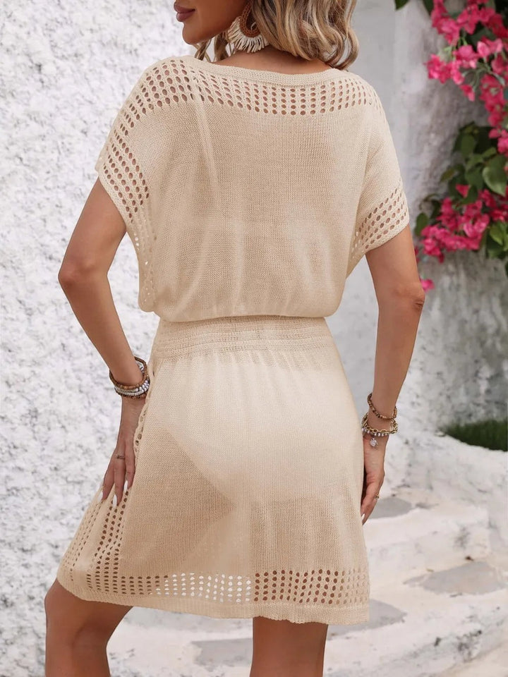Sea Dragon Dreams beige openwork short sleeve cover-up dress with a relaxed fit and V-neck, worn by a woman outdoors.