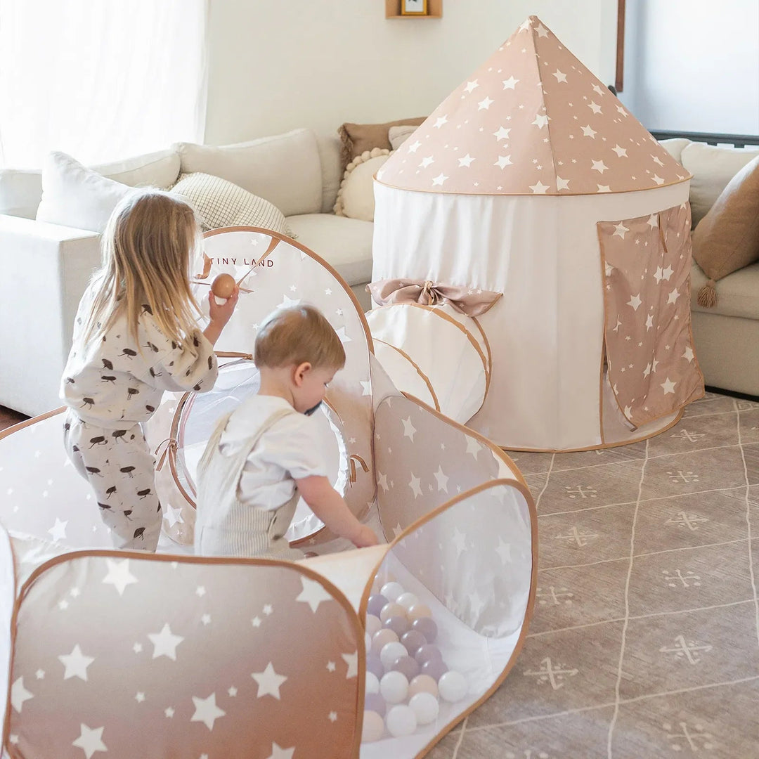 Sea Dragon Dreams Tiny Land 3-in-1 beige play tunnel, tent, and ball pit set with star patterns in a bright living room.