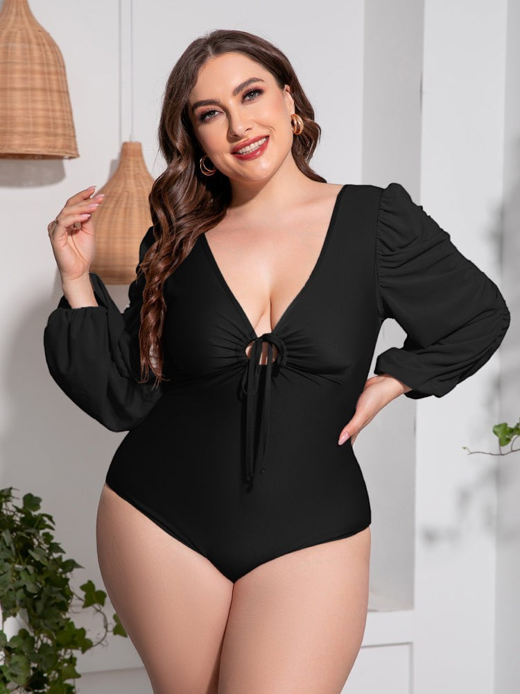 Sea Dragon Dreams plus size black one-piece swimsuit with deep V-neck, tie front, and long balloon sleeves