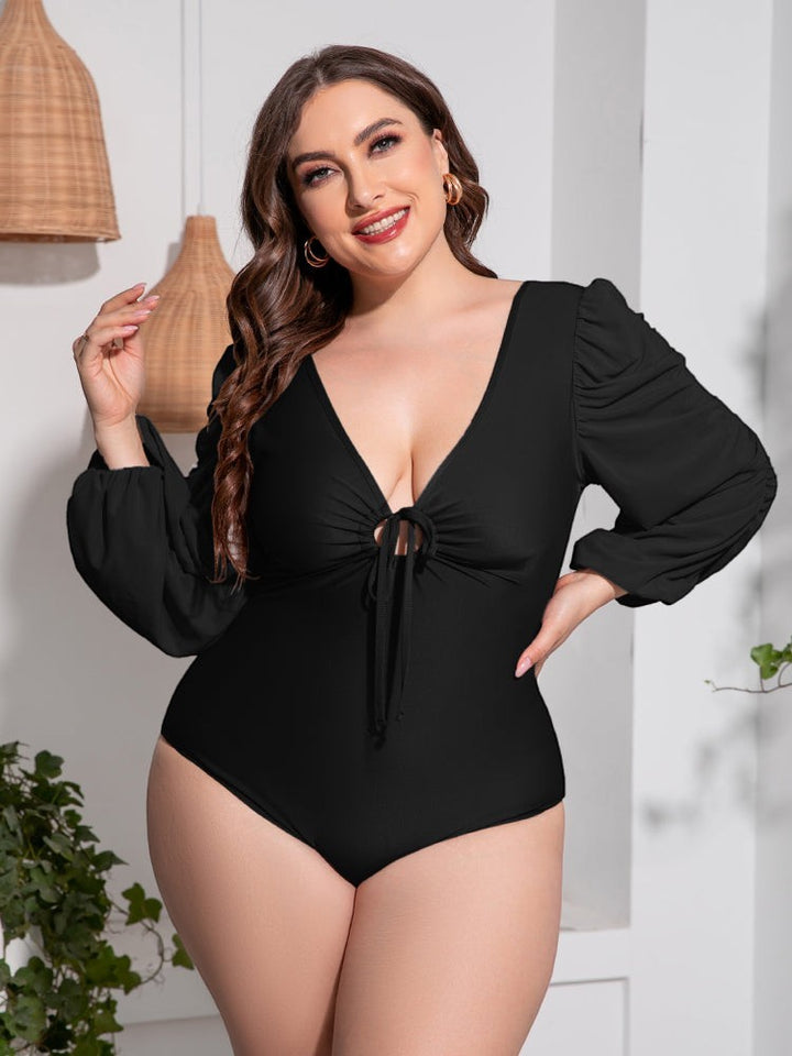 Sea Dragon Dreams plus size black one-piece swimsuit with deep V-neck, tie front, and long balloon sleeves