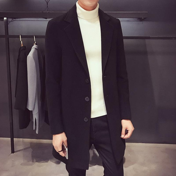 Sea Dragon Dreams men's black cotton trench coat with a turn-down collar worn over a white turtleneck sweater