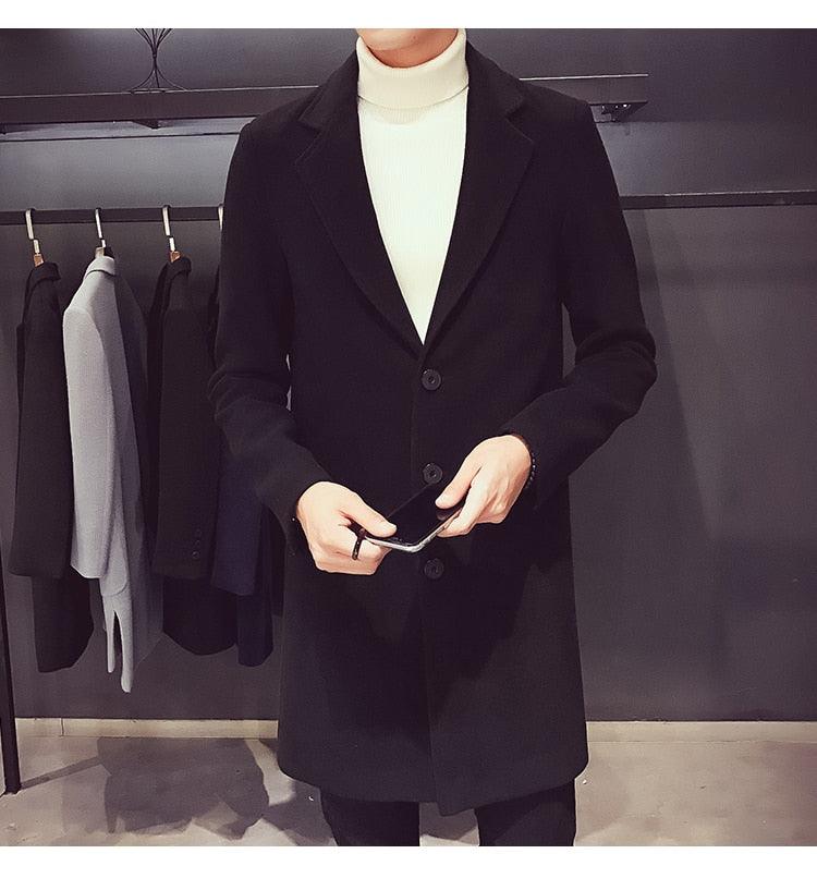 Sea Dragon Dreams men's black cotton trench coat with a turn-down collar, worn over a white turtleneck sweater.