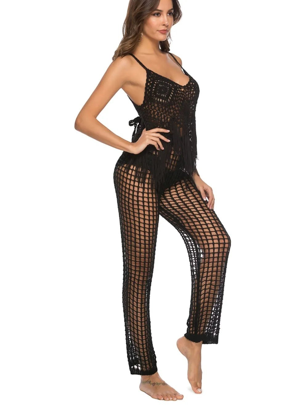 Model wearing Sea Dragon Dreams black crochet high waist swim pants with cutout details and matching fringe top