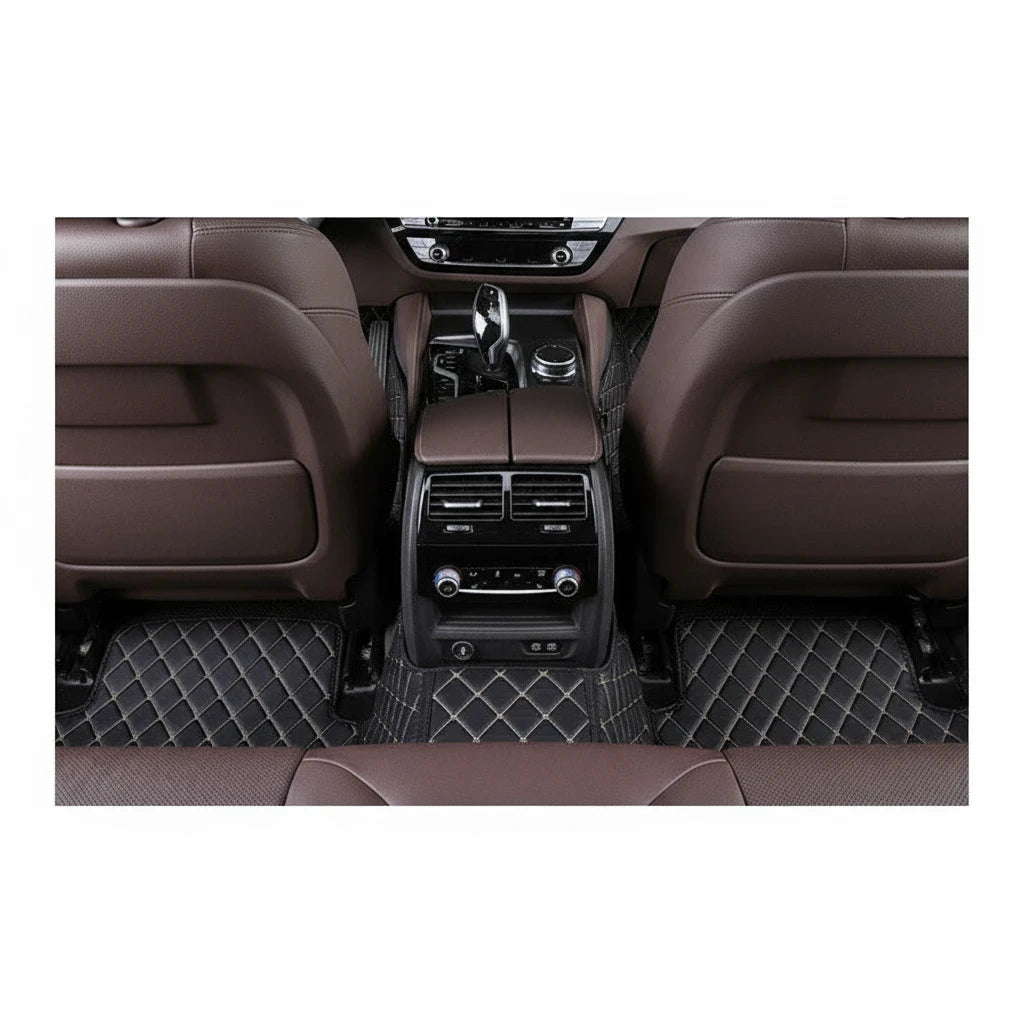Sea Dragon Dreams black TPE car floor mats with beige diamond stitching installed in the rear of a luxury vehicle.