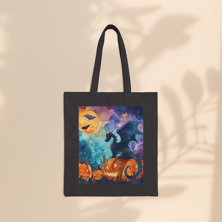 Sea Dragon Dreams black cotton canvas tote bag featuring a watercolor dragon perched on glowing jack-o'-lanterns.