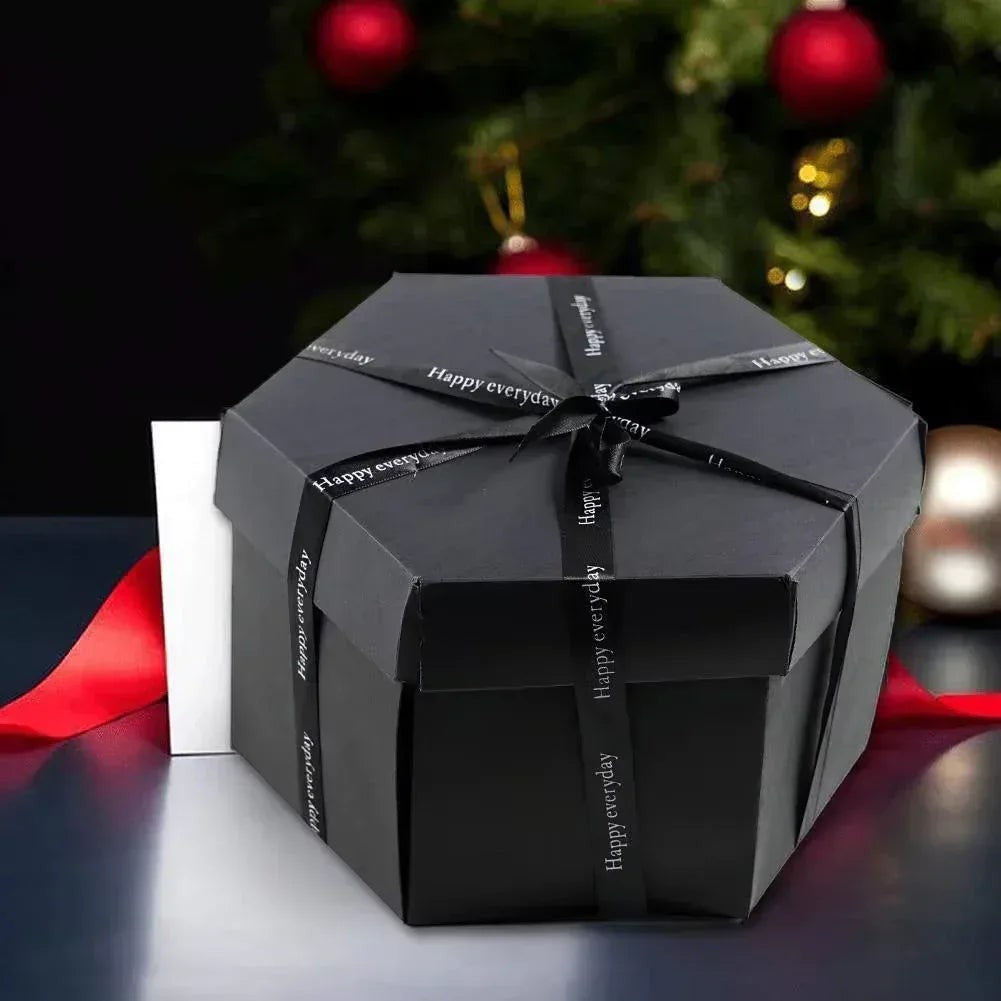 Sea Dragon Dreams black hexagonal explosion gift box tied with a ribbon, set against a festive holiday background.