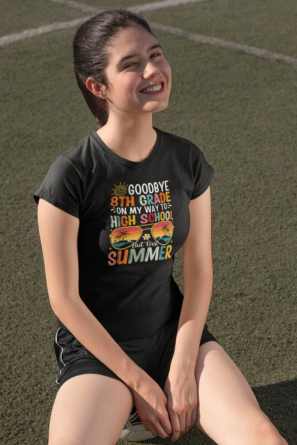 Sea Dragon Dreams black cotton kids graduation t-shirt with Goodbye 8th Grade summer graphic worn by a smiling girl.