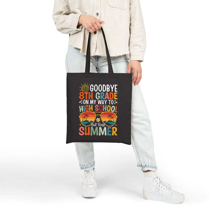 Sea Dragon Dreams black cotton canvas tote bag with colorful 8th grade graduation design held by a person
