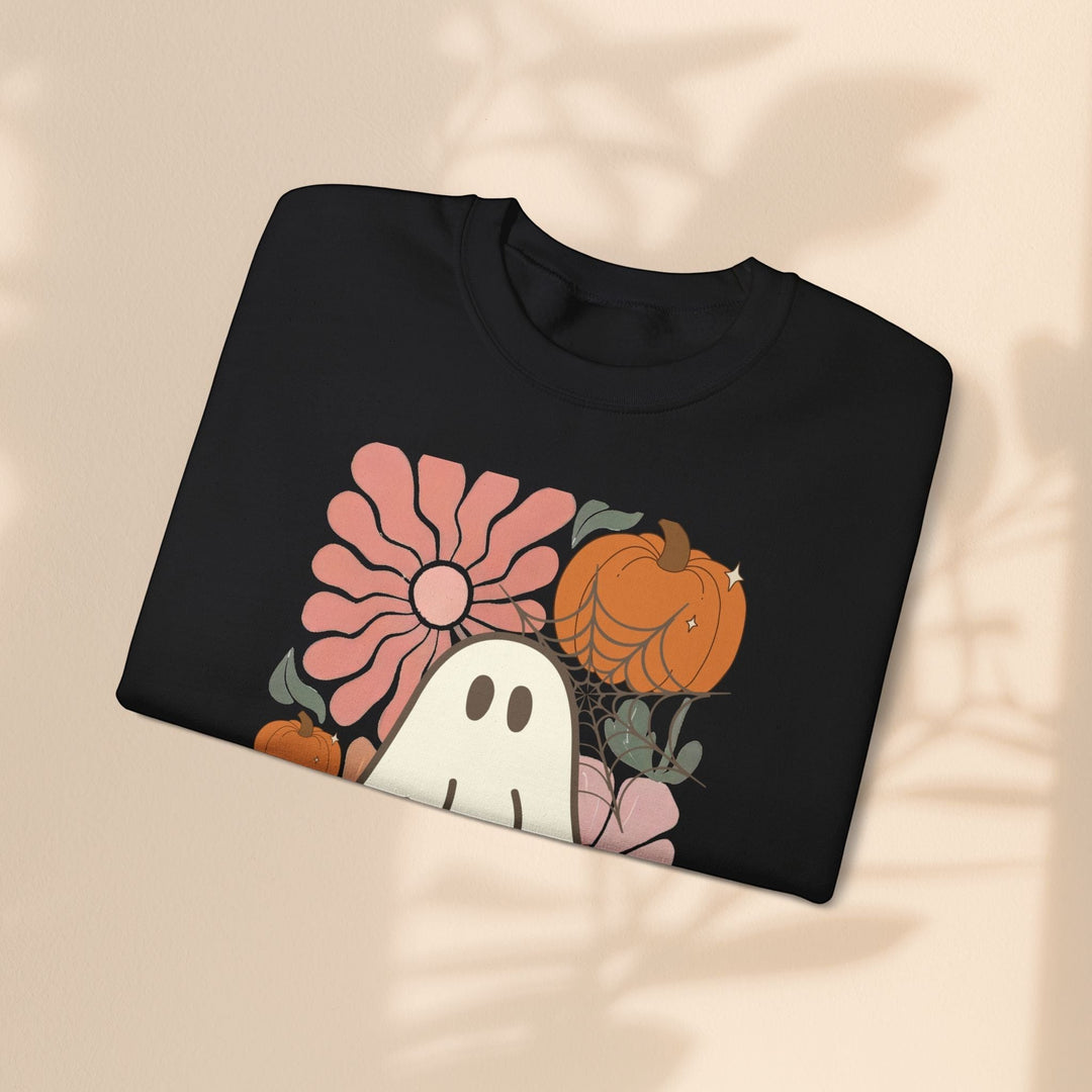 Sea Dragon Dreams black crewneck sweatshirt with a retro ghost, pumpkin, and floral Halloween graphic print.