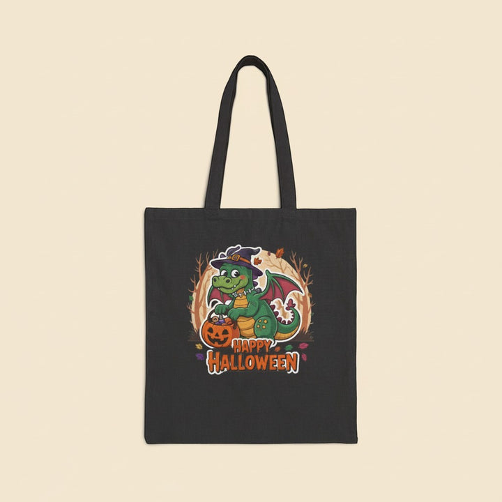 Sea Dragon Dreams black cotton canvas tote bag featuring a cute green dragon in a witch hat with a pumpkin
