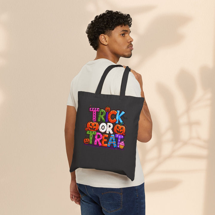 Sea Dragon Dreams black cotton canvas trick or treat tote bag with colorful Halloween graphic worn over shoulder