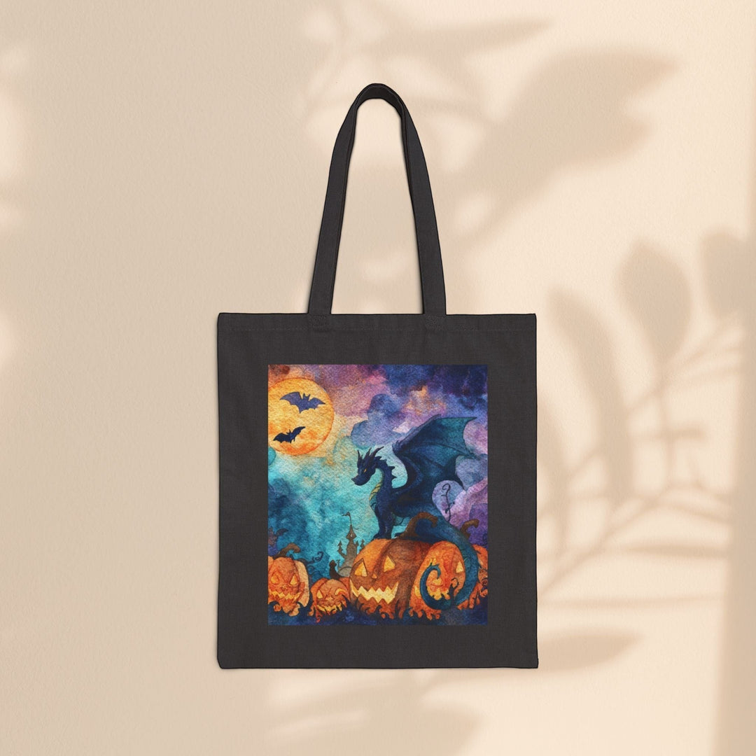Sea Dragon Dreams black cotton canvas tote bag featuring a watercolor dragon perched on glowing Halloween pumpkins