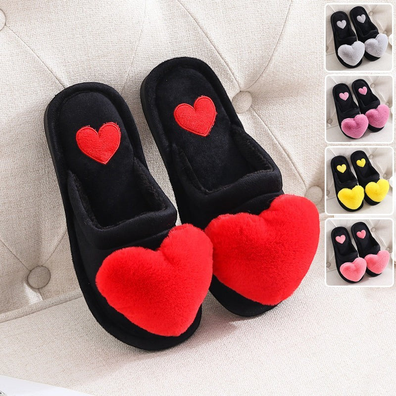Sea Dragon Dreams black plush house slippers featuring a large red fluffy heart on the toe and a small heart detail