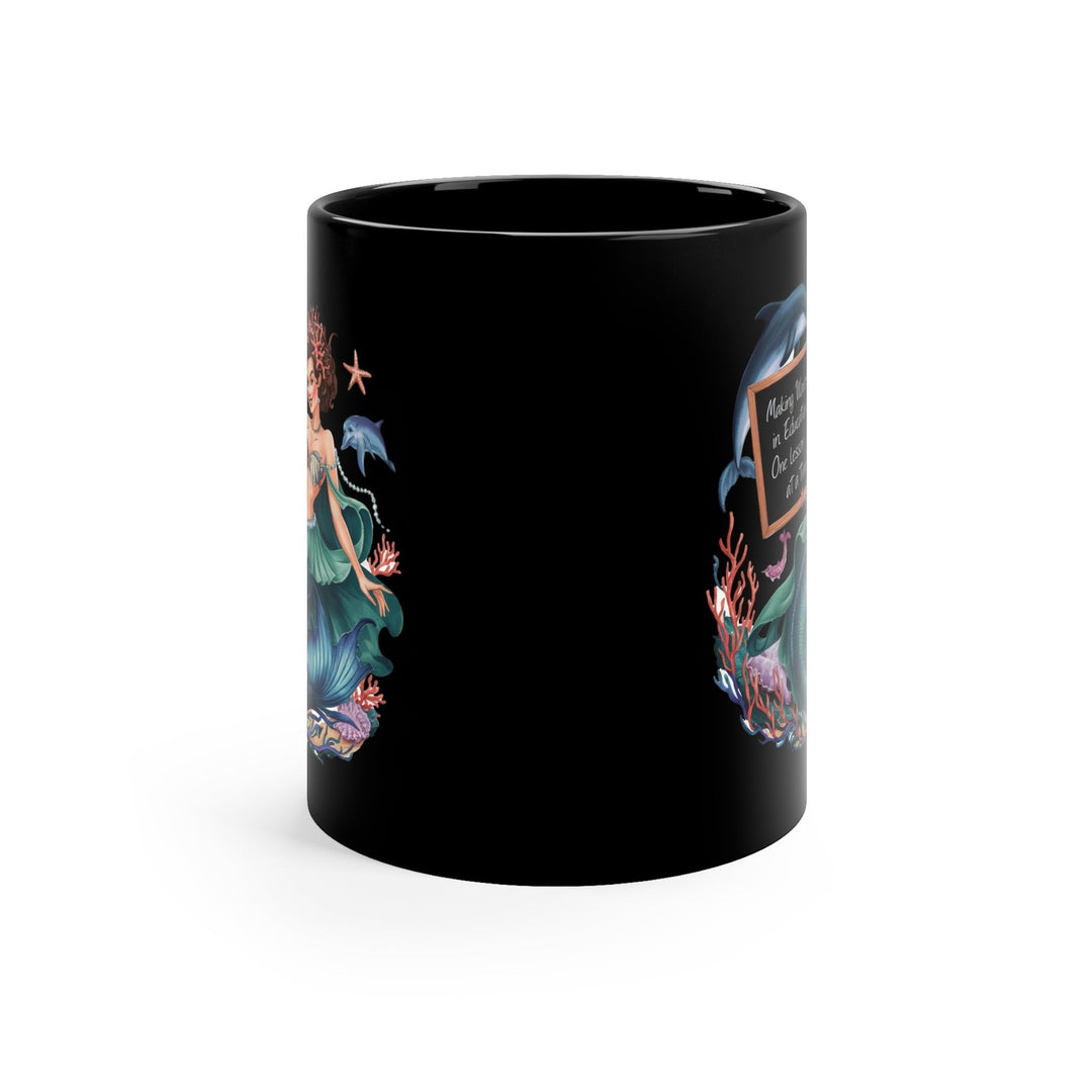 Sea Dragon Dreams black ceramic 11oz coffee mug featuring a mermaid and dolphin illustration with educational text.