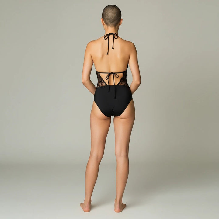 Sea Dragon Dreams black one-piece swimsuit with halter neck, sheer mesh waist detailing, and open back design