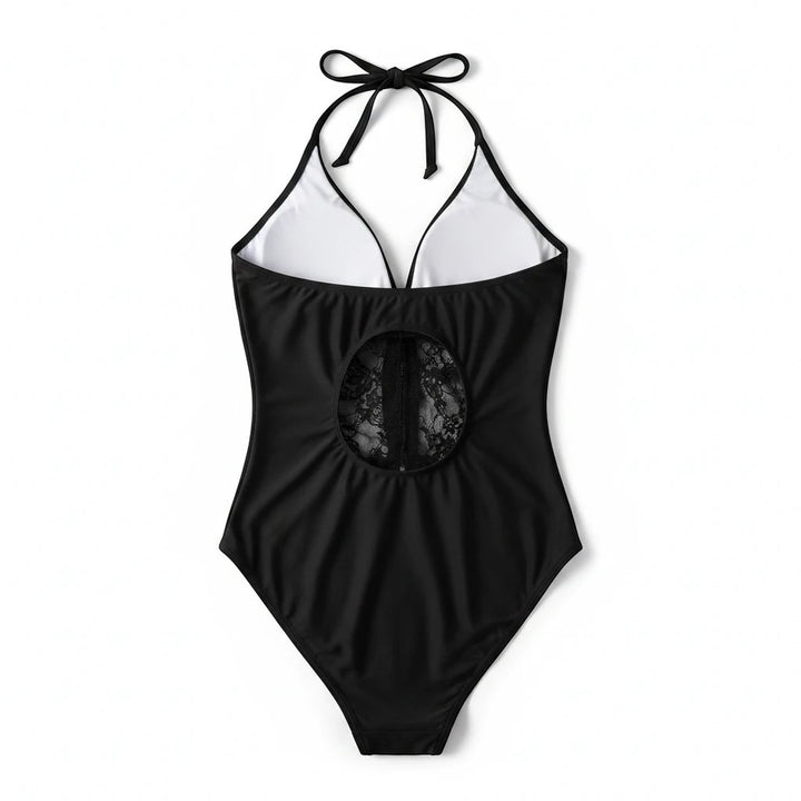 Sea Dragon Dreams black one-piece swimsuit with a halter neck, backless design, and intricate lace mesh cutout detail.