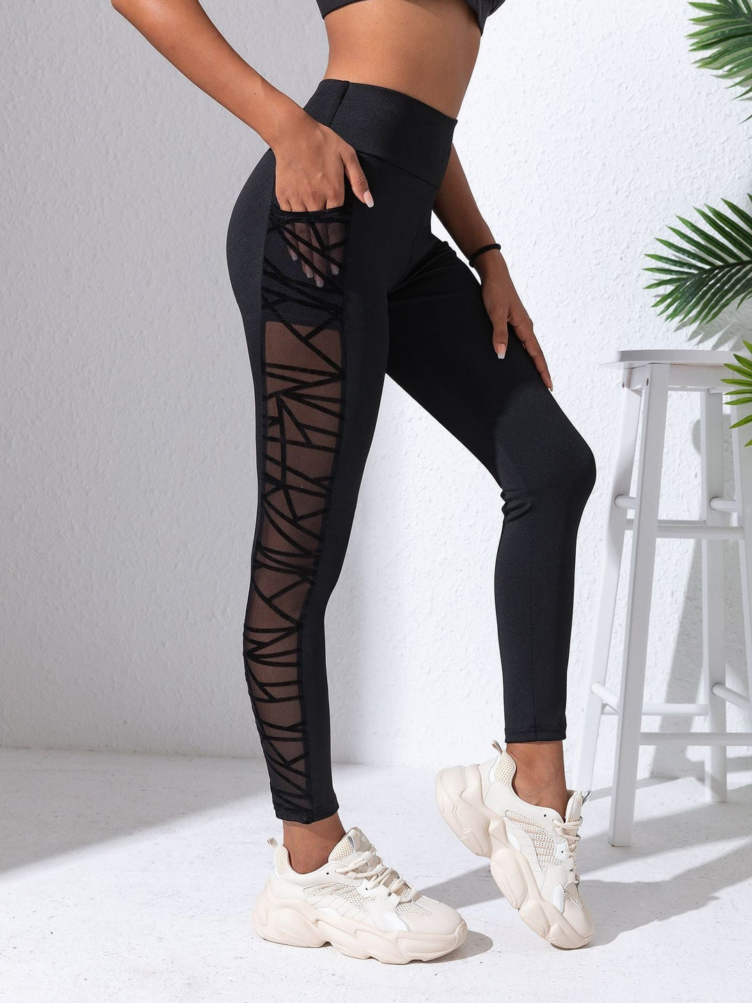 Sea Dragon Dreams black high-waist workout leggings with side mesh panels and geometric contrast stitching