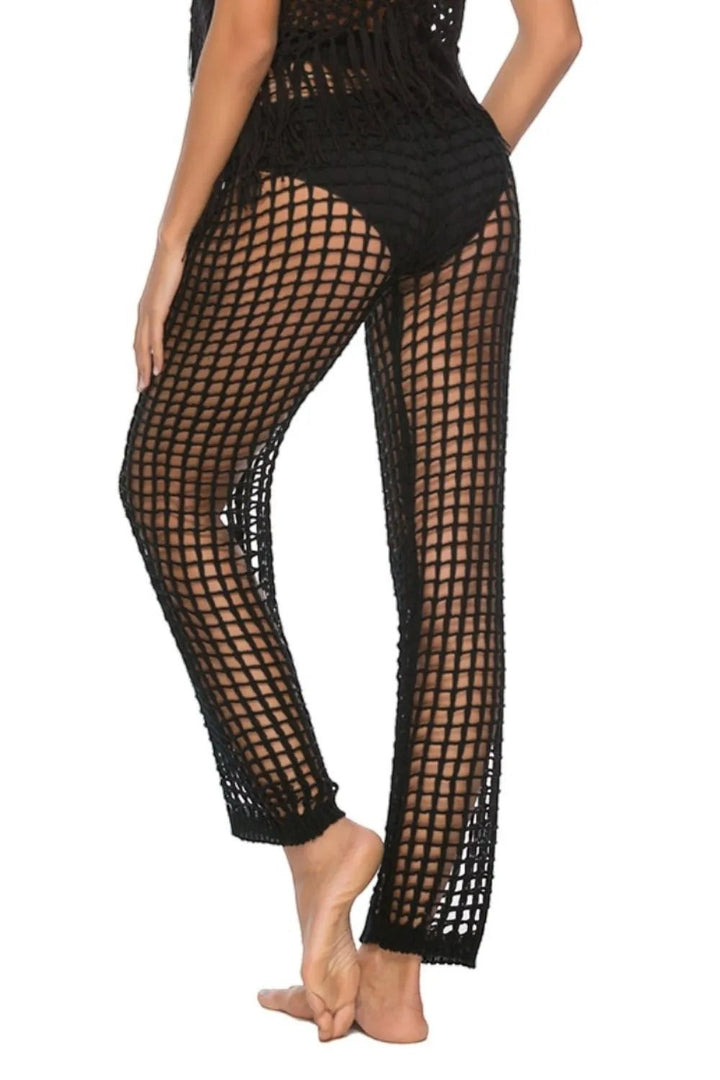 Sea Dragon Dreams black high-waisted mesh swim pants with cutout details worn by a model from a back view.