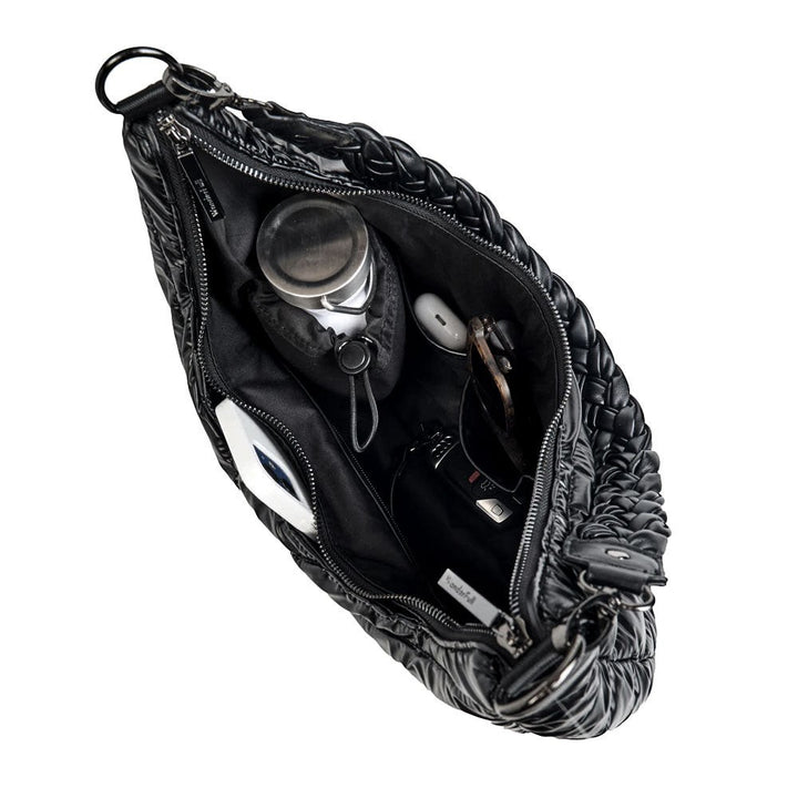 Sea Dragon Dreams Black Pearl HydroHobo bag interior with organized essentials and stainless steel water bottle.