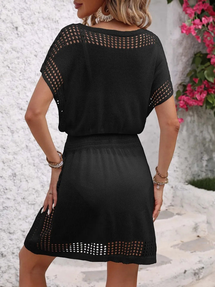 Sea Dragon Dreams black openwork short sleeve cover-up dress with a relaxed fit, worn from the back view.