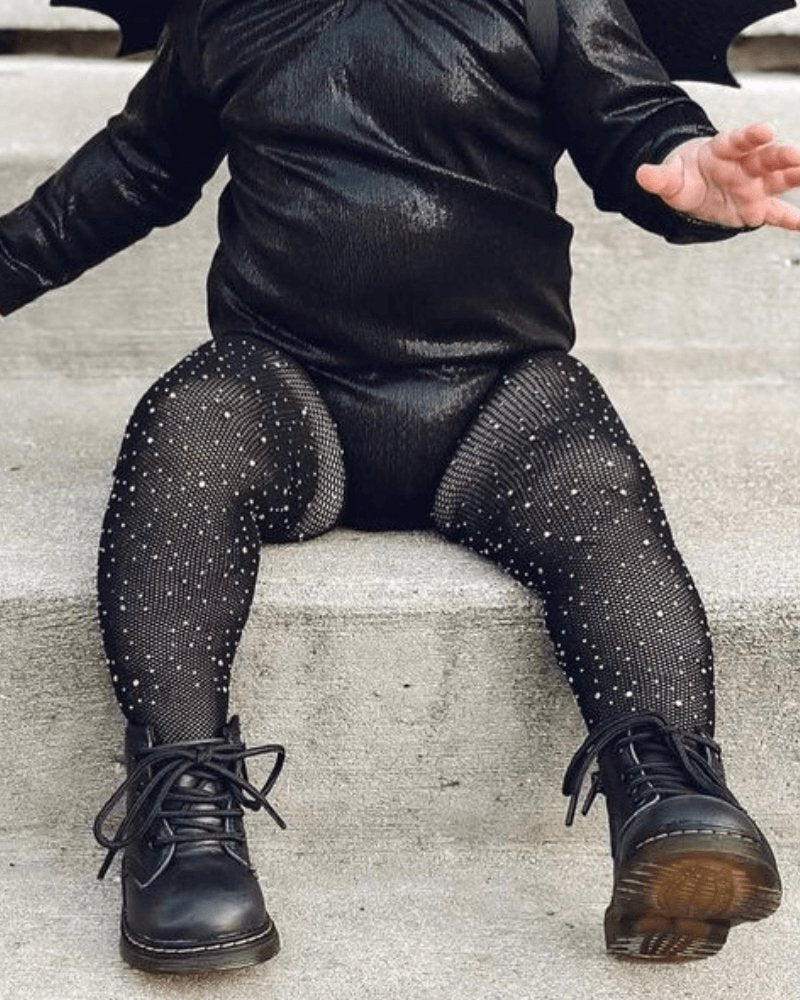 Sea Dragon Dreams black fishnet tights for girls featuring sparkling rhinestones, worn with black boots and outfit.