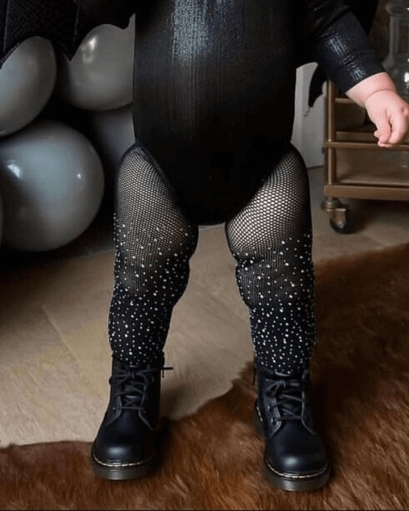 Sea Dragon Dreams black fishnet tights for girls featuring scattered rhinestones, worn with black boots and bodysuit