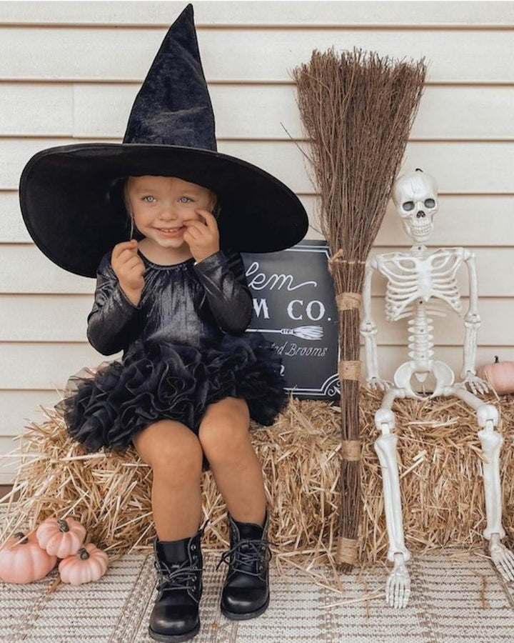 Sea Dragon Dreams girls' shimmering black long sleeve leotard worn as a witch costume with a tutu and hat