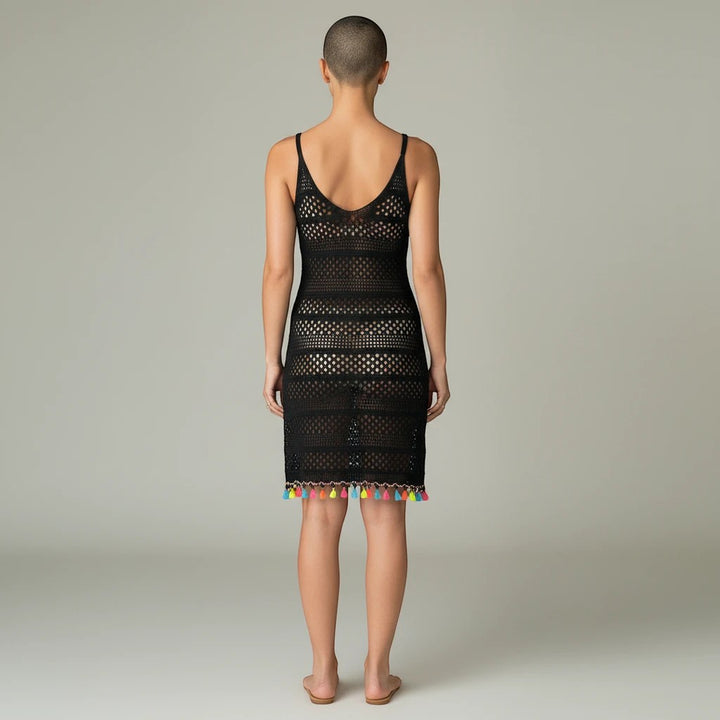 Sea Dragon Dreams black hollow-out woven beach cover-up dress with colorful tassel hem, back view on a model