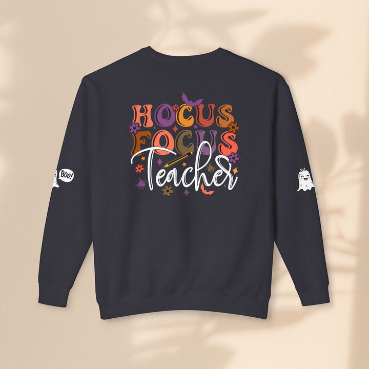 Sea Dragon Dreams black crewneck sweatshirt with Hocus Focus Teacher Halloween graphic and ghost sleeve details.