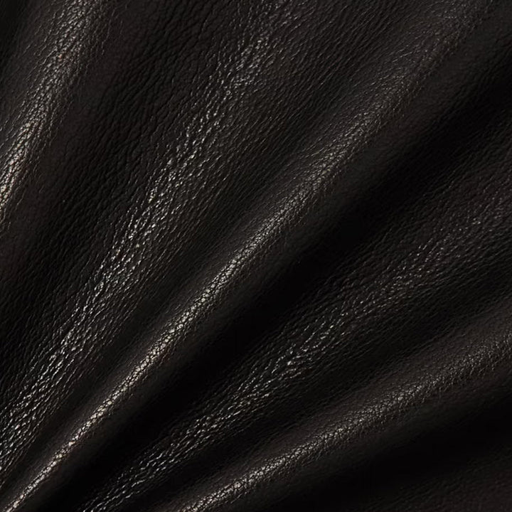 Close-up of black textured leather material from a Sea Dragon Dreams jacket showing grain and folds