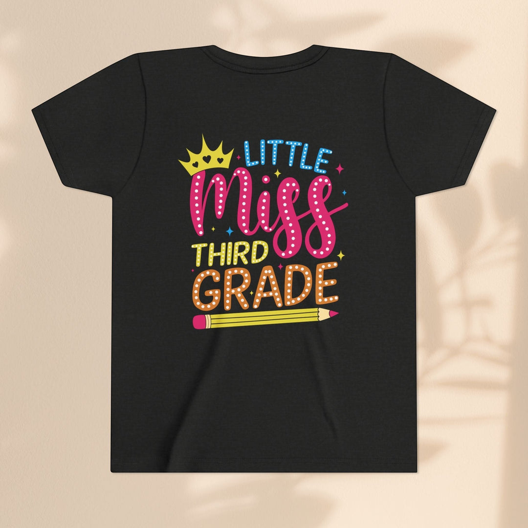 Sea Dragon Dreams black youth t-shirt with Little Miss Third Grade graphic featuring a crown and pencil design.
