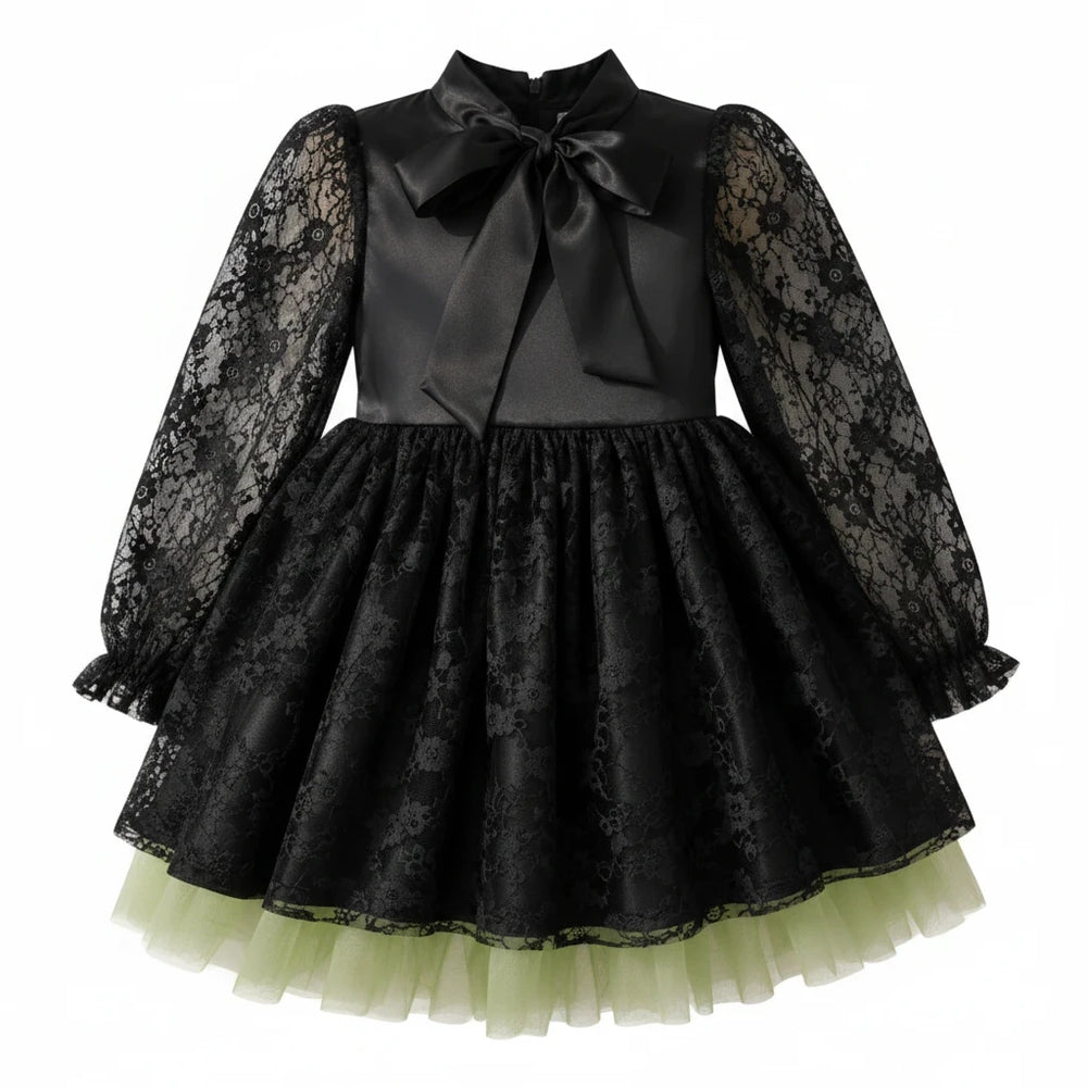 Sea Dragon Dreams girls' black satin witch dress with lace sleeves, bow neckline, and green tulle hem for Halloween.